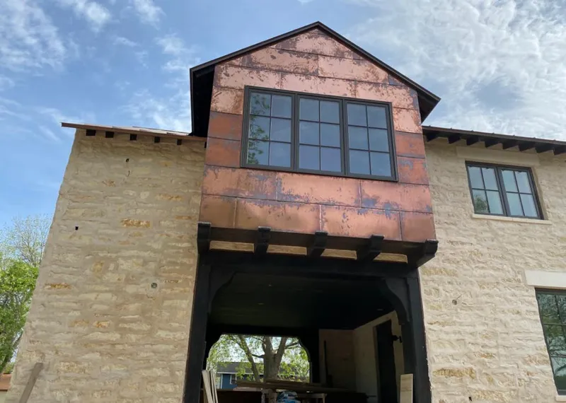 Copper metal panel facade on a stone building for Skylight Installation in Battlement Mesa